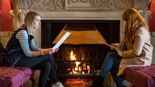 Visitors in front of the Entrance Hall fire at Stourhead house.